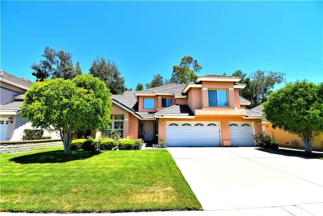 29058 Rosewood Ln, Highland, CA 92346 - view of front facade with stucco siding, a garage, a front lawn, concrete driveway, and a tile roof