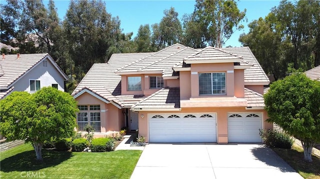 29058 Rosewood Ln, Highland, CA 92346 - view of front of house with stucco siding, a garage, driveway, a tiled roof, and a front lawn