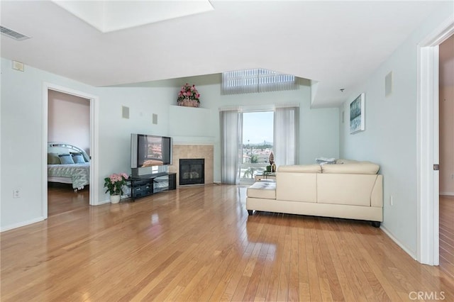 580 W Main St Unit 323, Alhambra, CA 91801 - living area featuring light wood-style flooring, a tile fireplace, and baseboards