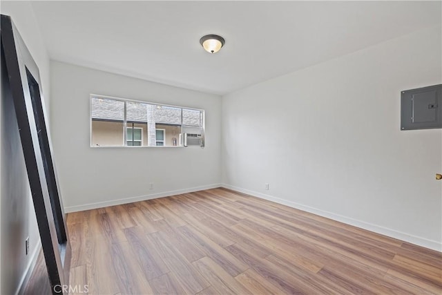 1273 E Appleton St Unit 4, Long Beach, CA 90802 - unfurnished bedroom with wood finished floors, electric panel, cooling unit, and baseboards