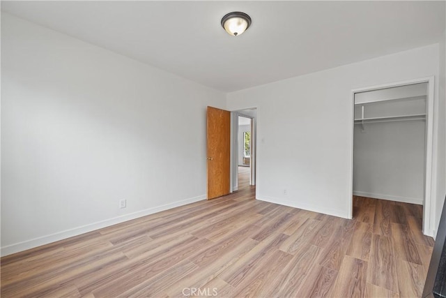 1273 E Appleton St Unit 4, Long Beach, CA 90802 - unfurnished bedroom featuring light wood-type flooring, a closet, and a spacious closet