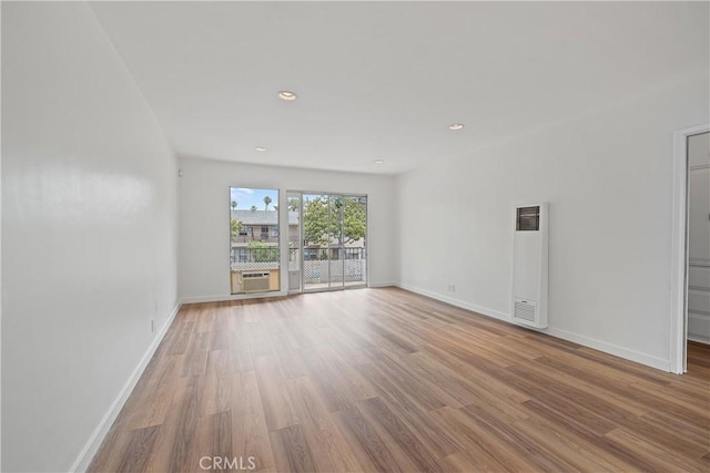 1273 E Appleton St Unit 4, Long Beach, CA 90802 - empty room featuring a heating unit, baseboards, wood finished floors, and recessed lighting