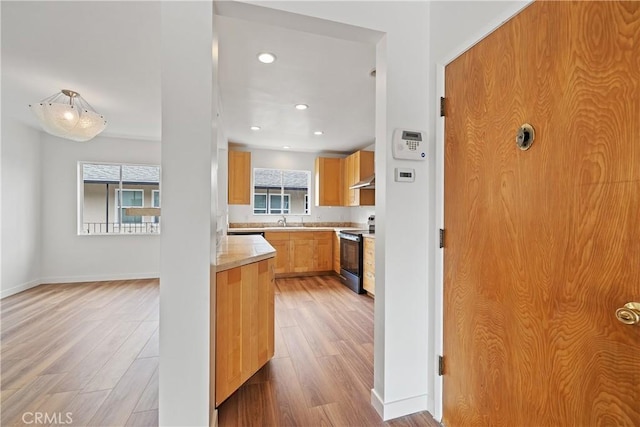 1273 E Appleton St Unit 4, Long Beach, CA 90802 - kitchen featuring black electric range, light wood-style floors, light countertops, recessed lighting, and baseboards