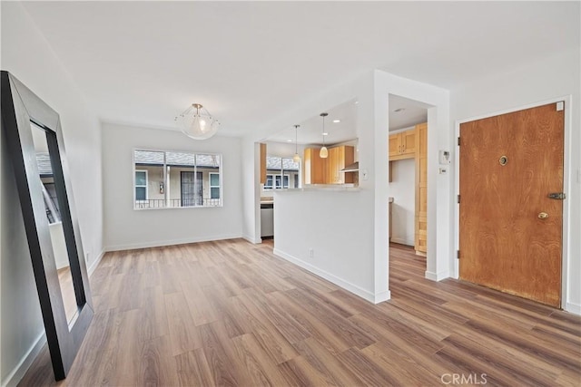 1273 E Appleton St Unit 4, Long Beach, CA 90802 - unfurnished living room featuring light wood-style flooring and baseboards