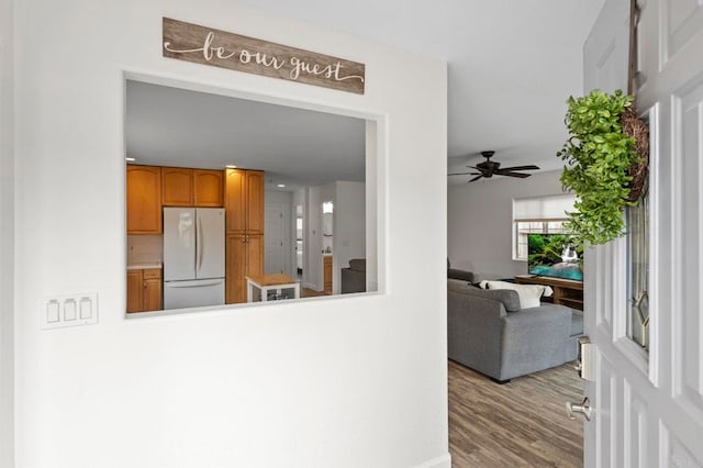 1125 Arcadia Rd, Encinitas, CA 92024 - kitchen with freestanding refrigerator, ceiling fan, brown cabinets, and wood finished floors