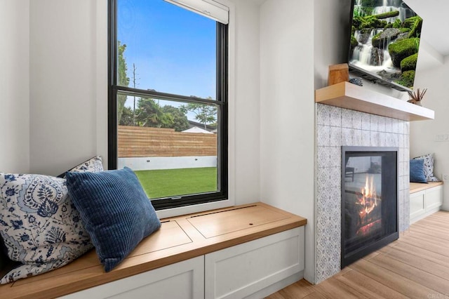 1125 Arcadia Rd, Encinitas, CA 92024 - sitting room featuring a tiled fireplace and light wood finished floors