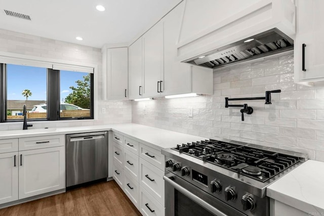 1125 Arcadia Rd, Encinitas, CA 92024 - kitchen with stainless steel appliances, custom exhaust hood, white cabinetry, decorative backsplash, and recessed lighting