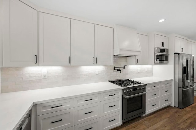 1125 Arcadia Rd, Encinitas, CA 92024 - kitchen featuring appliances with stainless steel finishes, premium range hood, white cabinetry, dark wood finished floors, and recessed lighting