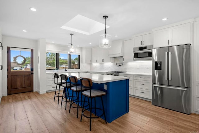 1125 Arcadia Rd, Encinitas, CA 92024 - kitchen featuring stainless steel appliances, custom exhaust hood, light wood-style floors, light countertops, and tasteful backsplash