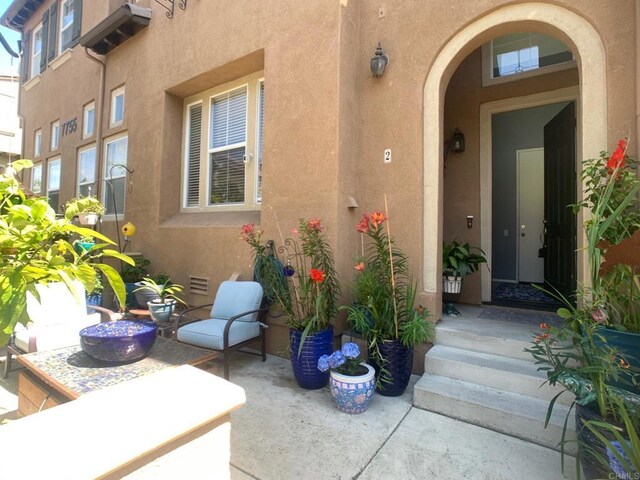 7755 Via Montebello Unit 2, San Diego, CA 92129 - entrance to property featuring stucco siding and a patio area
