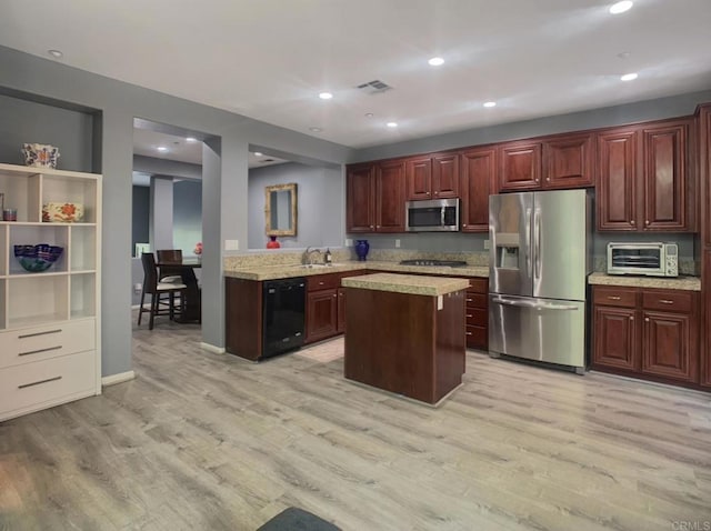 7755 Via Montebello Unit 2, San Diego, CA 92129 - kitchen featuring stainless steel appliances, light wood-style flooring, recessed lighting, a kitchen island, and dark brown cabinets
