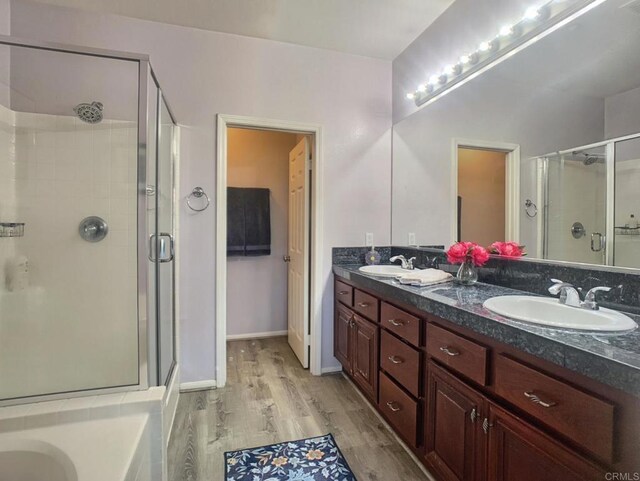 7755 Via Montebello Unit 2, San Diego, CA 92129 - full bath with a stall shower, wood finished floors, double vanity, and a tub