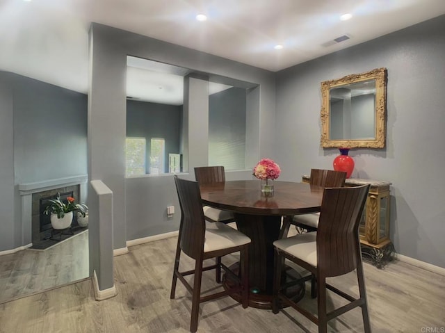 7755 Via Montebello Unit 2, San Diego, CA 92129 - dining area with light wood-type flooring, a tiled fireplace, and recessed lighting