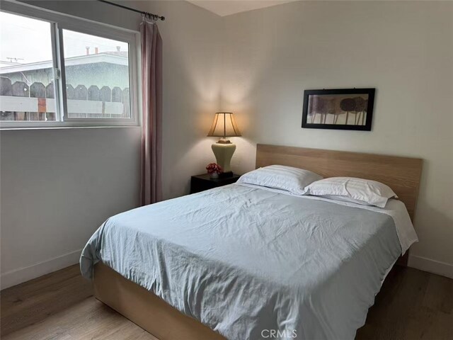 951 E Elma St, Ontario, CA 91764 - bedroom with baseboards and wood finished floors