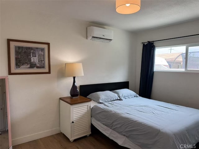 951 E Elma St, Ontario, CA 91764 - bedroom with a wall mounted AC, wood finished floors, and baseboards