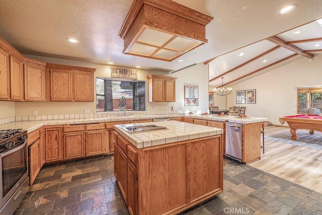 42756 Tannenbaum Platz, Big Bear Lake, CA 92315 - kitchen with stainless steel appliances, a peninsula, tile countertops, a textured ceiling, and recessed lighting