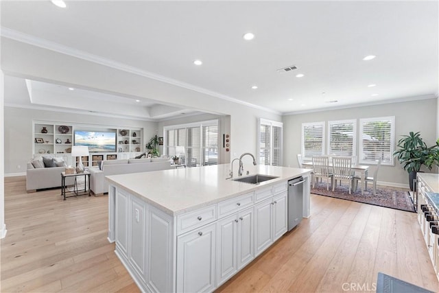 288 Shorey Dr, Glendora, CA 91741 - kitchen featuring stainless steel dishwasher, a sink, light wood-style floors, white cabinets, and ornamental molding