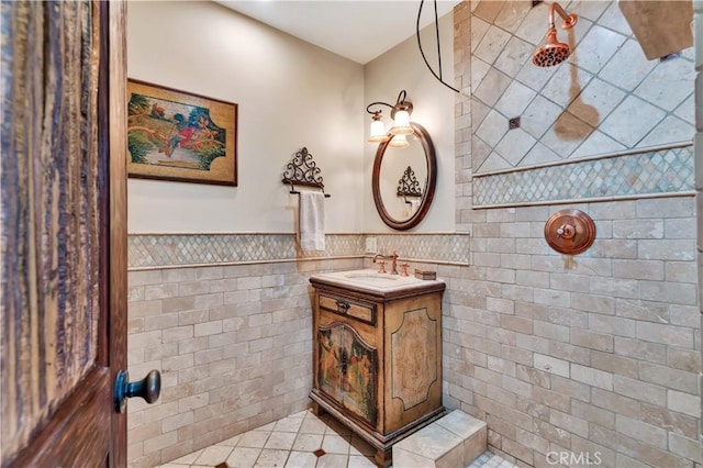 128 Rocky Point Rd, Palos Verdes Estates, CA 90274 - full bath featuring vanity, tile walls, tile patterned flooring, a wainscoted wall, and a tile shower