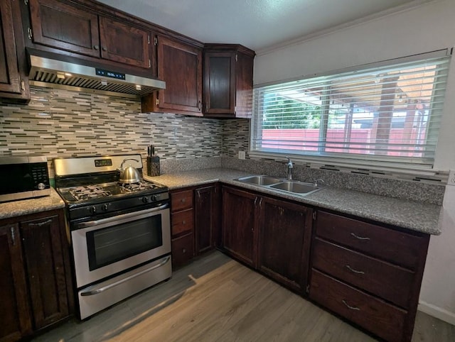 751 Glenwood Ln, Willows, CA 95988 - kitchen featuring appliances with stainless steel finishes, a sink, under cabinet range hood, light wood-style floors, and tasteful backsplash