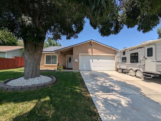 751 Glenwood Ln, Willows, CA 95988 - ranch-style house with stucco siding, solar panels, a garage, and concrete driveway