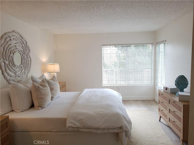 1406 Brett Pl Unit 112, San Pedro, CA 90732 - bedroom featuring light wood finished floors and a textured ceiling