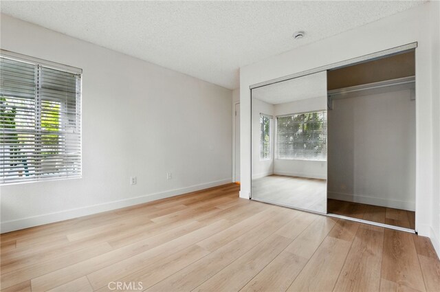 1406 Brett Pl Unit 112, San Pedro, CA 90732 - unfurnished bedroom featuring wood finished floors, a closet, and a textured ceiling