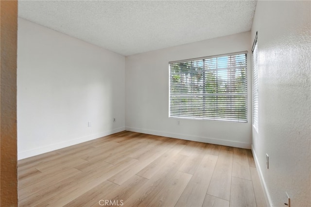1406 Brett Pl Unit 112, San Pedro, CA 90732 - spare room featuring light wood-type flooring and a textured ceiling