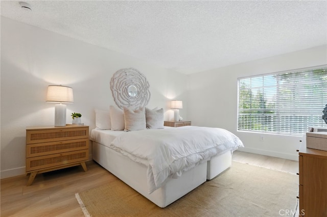 1406 Brett Pl Unit 112, San Pedro, CA 90732 - bedroom featuring light wood-type flooring and a textured ceiling