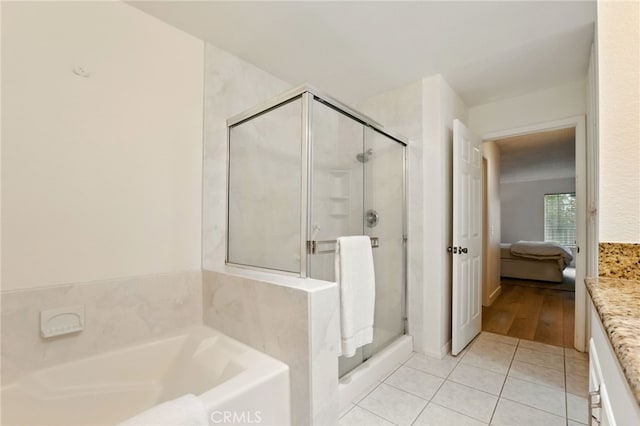 1406 Brett Pl Unit 112, San Pedro, CA 90732 - bathroom featuring ensuite bath, a garden tub, a shower stall, and tile patterned flooring
