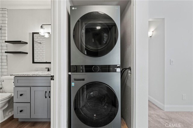 26904 Flo Ln Unit 456, Canyon Country, CA 91351 - laundry area with stacked washer and clothes dryer and baseboards