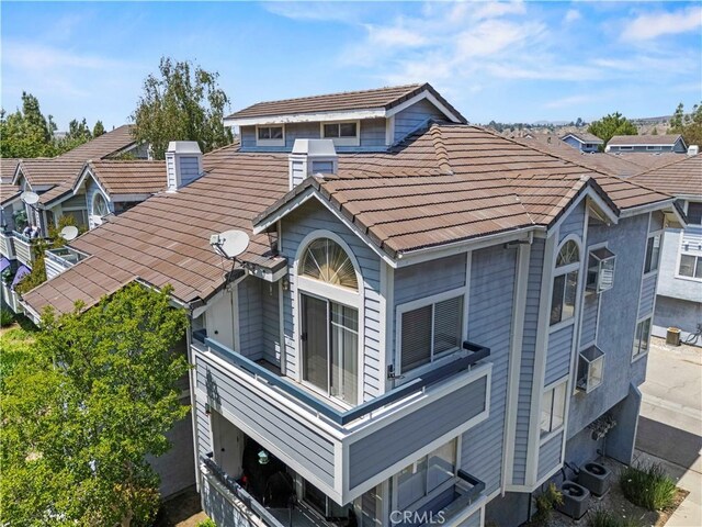 26904 Flo Ln Unit 456, Canyon Country, CA 91351 - rear view of property featuring a tile roof and central air condition unit