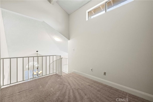 26904 Flo Ln Unit 456, Canyon Country, CA 91351 - carpeted empty room with vaulted ceiling, baseboards, and a chandelier
