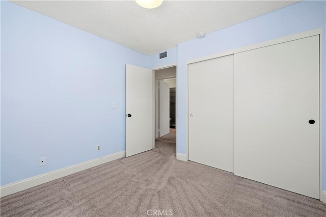 26904 Flo Ln Unit 456, Canyon Country, CA 91351 - unfurnished bedroom featuring carpet floors, a closet, a textured ceiling, and baseboards