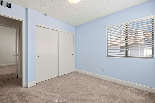 26904 Flo Ln Unit 456, Canyon Country, CA 91351 - unfurnished bedroom featuring carpet, a closet, a textured ceiling, and baseboards