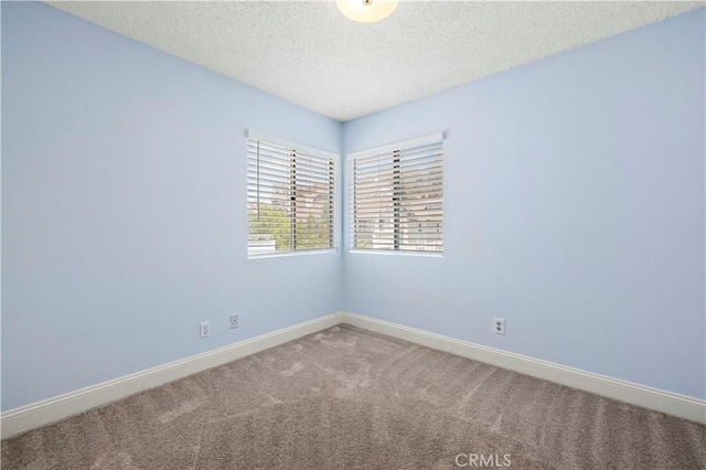 26904 Flo Ln Unit 456, Canyon Country, CA 91351 - carpeted spare room with a textured ceiling and baseboards