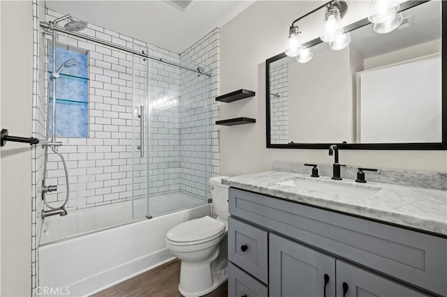26904 Flo Ln Unit 456, Canyon Country, CA 91351 - full bath featuring vanity, enclosed tub / shower combo, toilet, and wood finished floors