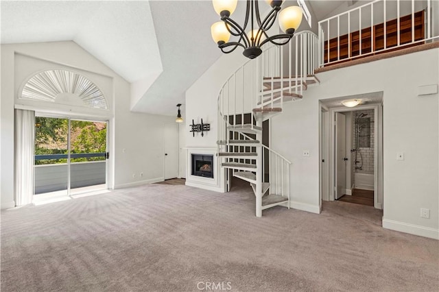 26904 Flo Ln Unit 456, Canyon Country, CA 91351 - unfurnished living room with carpet, stairs, baseboards, a chandelier, and high vaulted ceiling