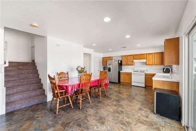 16029 White Mountain Pl, Victorville, CA 92394 - dining area with stairway, recessed lighting, a textured ceiling, and stone finish flooring