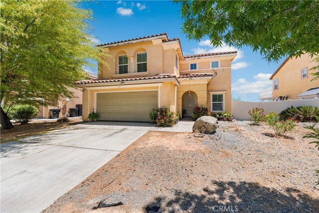16029 White Mountain Pl, Victorville, CA 92394 - mediterranean / spanish house with a tile roof, stucco siding, an attached garage, and concrete driveway