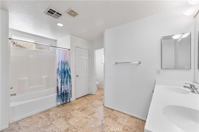 16029 White Mountain Pl, Victorville, CA 92394 - full bath featuring toilet, double vanity, shower / bath combination with curtain, baseboards, and a textured ceiling