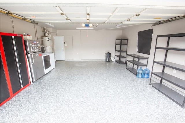572 Willowgrove Ave, Glendora, CA 91741 - garage with strapped water heater, freestanding refrigerator, washing machine and clothes dryer, a garage door opener, and baseboards