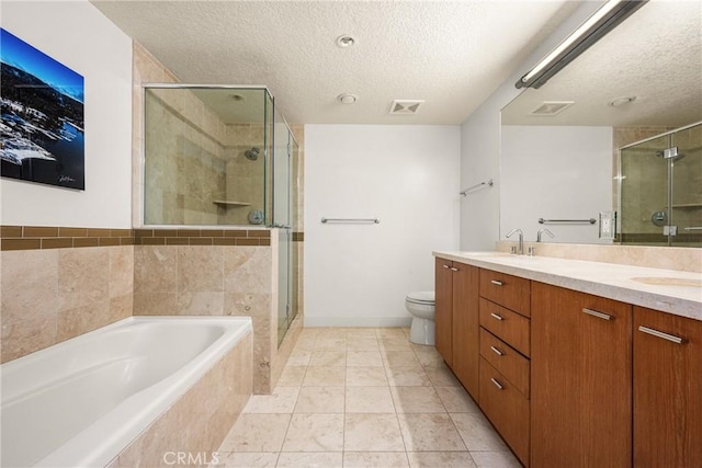 3131 Michelson Dr Unit 606, Irvine, CA 92612 - bathroom featuring a textured ceiling, a garden tub, a stall shower, double vanity, and toilet