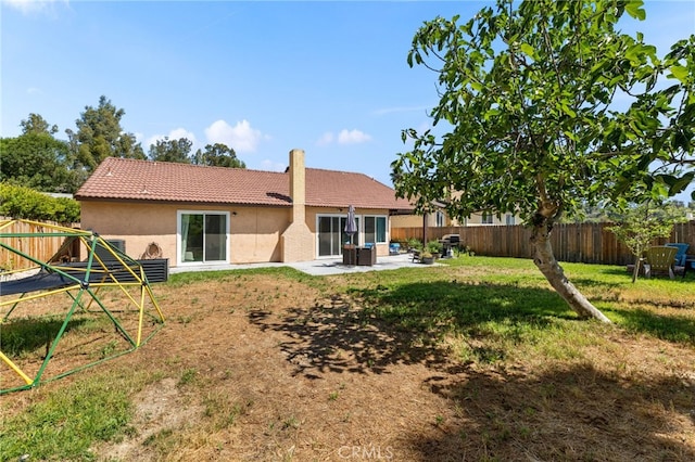 29951 Cactus Pl, Temecula, CA 92592 - rear view of property featuring a tile roof, stucco siding, a fenced backyard, a chimney, and a patio