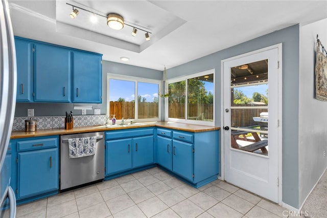 29951 Cactus Pl, Temecula, CA 92592 - kitchen featuring appliances with stainless steel finishes, blue cabinetry, a tray ceiling, and light tile patterned floors