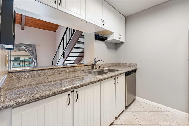 5460 White Oak Ave Unit E339, Encino, CA 91316 - kitchen with dishwasher, a sink, baseboards, light countertops, and light tile patterned floors