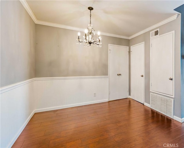 5460 White Oak Ave Unit E339, Encino, CA 91316 - unfurnished dining area with a chandelier, a wainscoted wall, crown molding, and hardwood / wood-style flooring