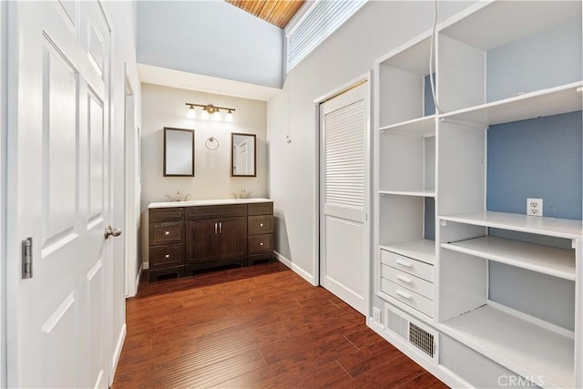 5460 White Oak Ave Unit E339, Encino, CA 91316 - bathroom featuring vanity, wood finished floors, a towering ceiling, and baseboards