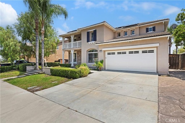 8581 Camino Limon Rd, Corona, CA 92883 - view of front of property featuring a balcony, concrete driveway, solar panels, and stucco siding