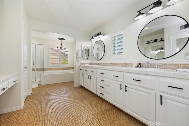 8581 Camino Limon Rd, Corona, CA 92883 - full bath with double vanity, a chandelier, a garden tub, and a shower stall