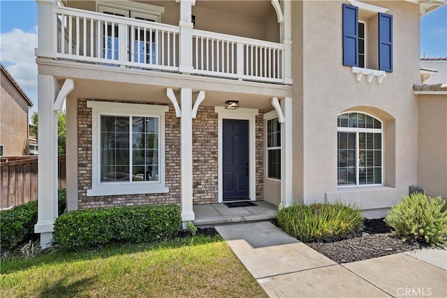 8581 Camino Limon Rd, Corona, CA 92883 - view of exterior entry with a balcony, stucco siding, and stone siding
